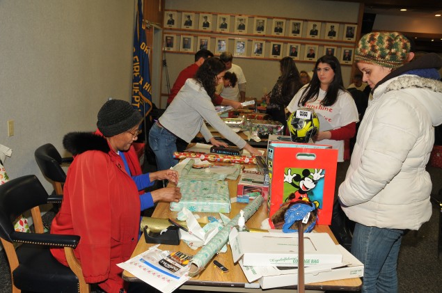 Volunteers wrap toys at the Sunshine Toy Drive at the Dix Hills Fire Department. 