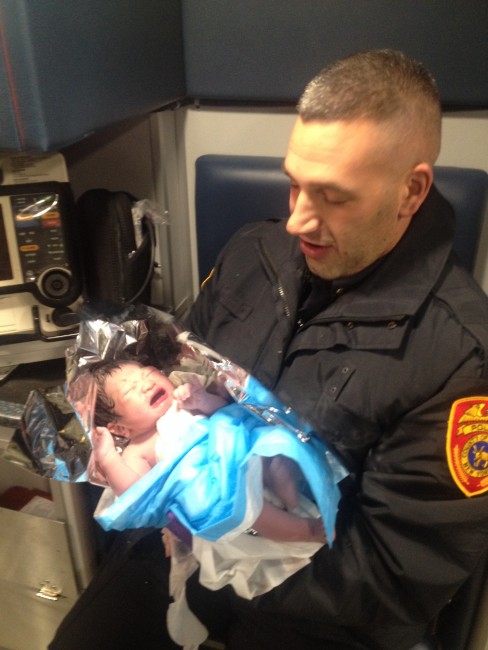 Police Officers Jonathan Murray, with the baby they helped deliver. 