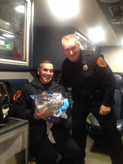 Police Officers Jonathan Murray, and Gerard Maxim with the baby they helped deliver.